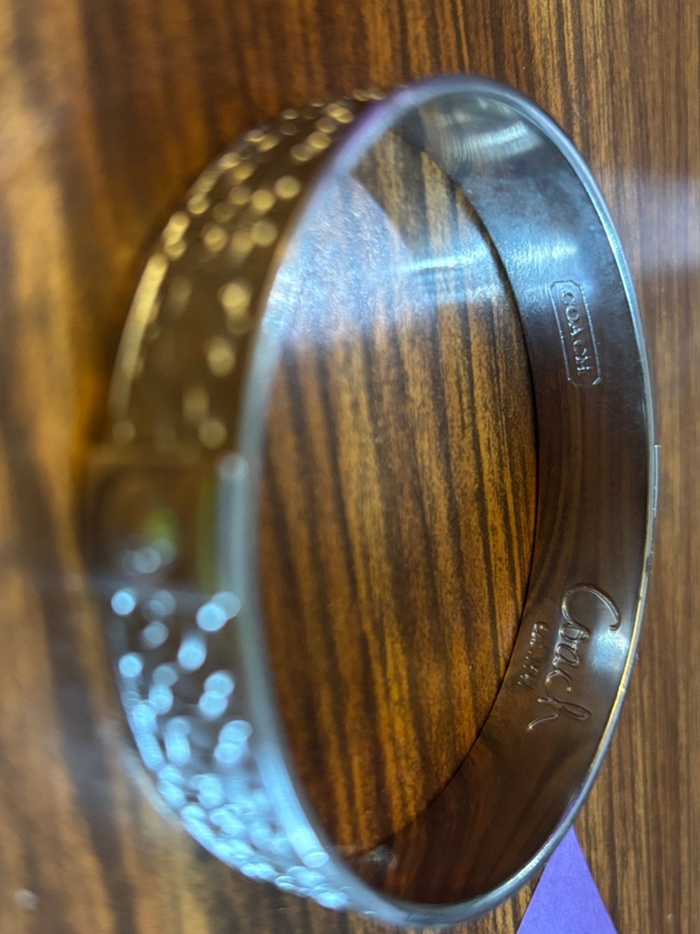 Coach Silver-Tone Signature Engraved Hinged Bangle